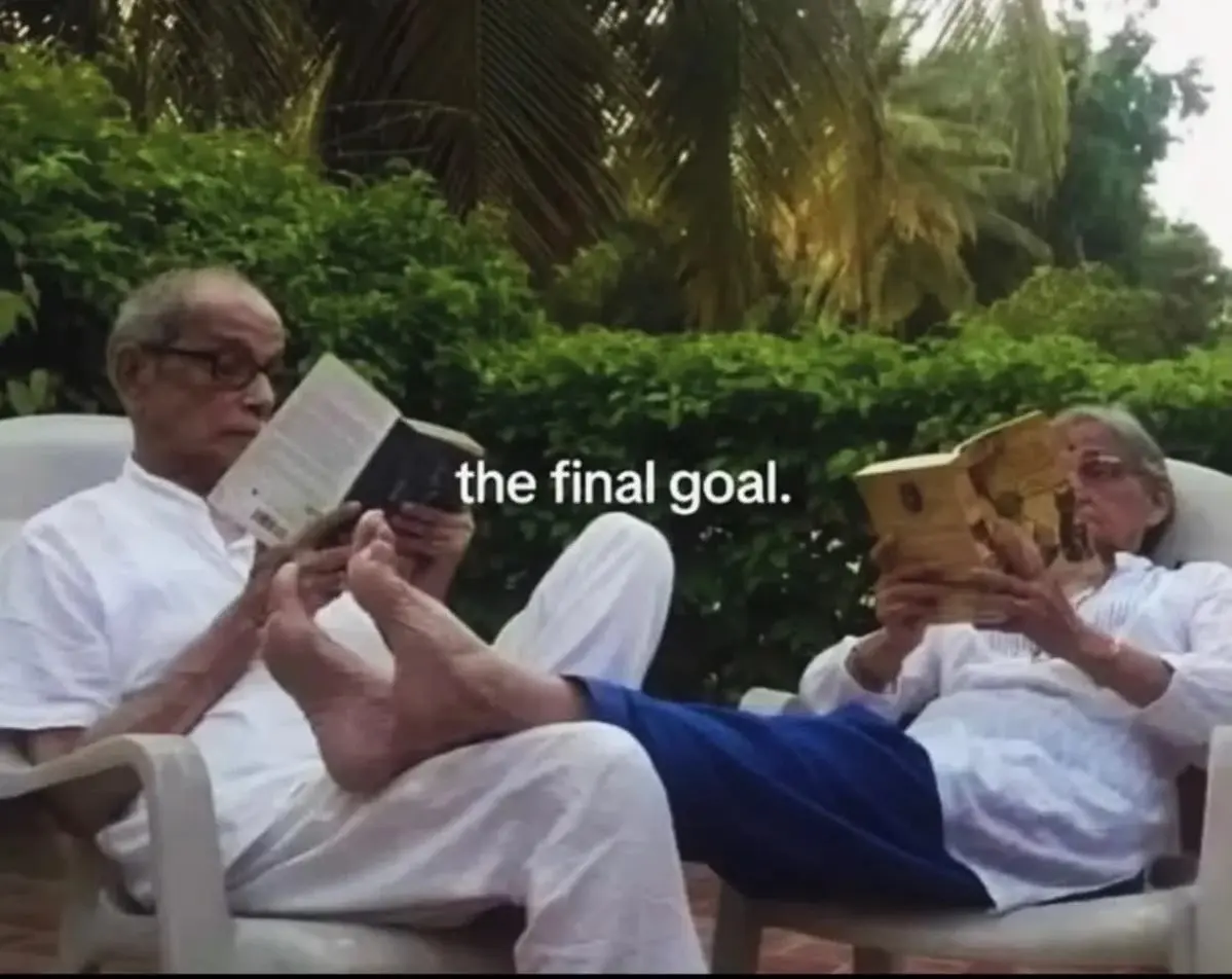 Two people sitting comfortably, reading books