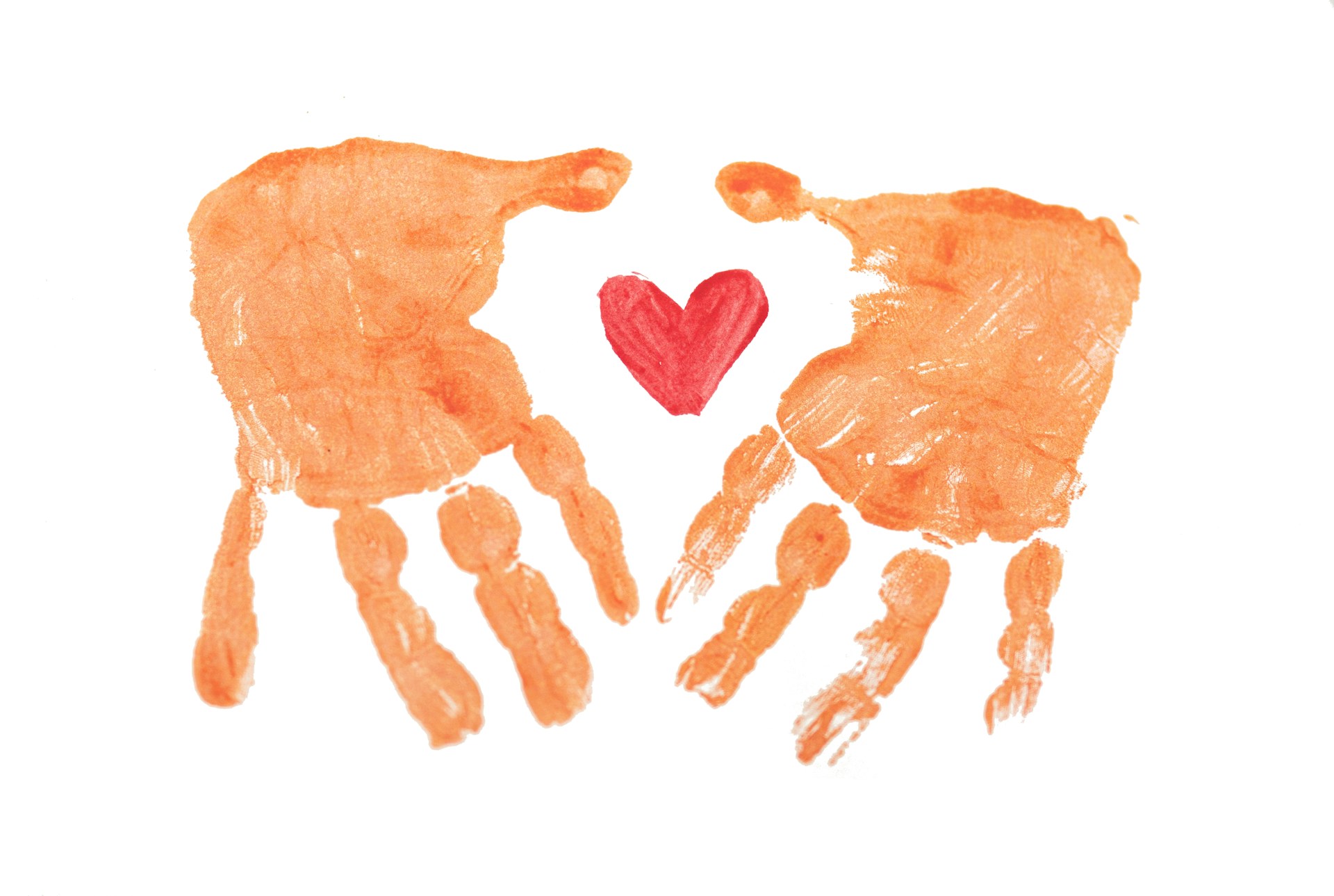 Two handprints with a heart in the middle