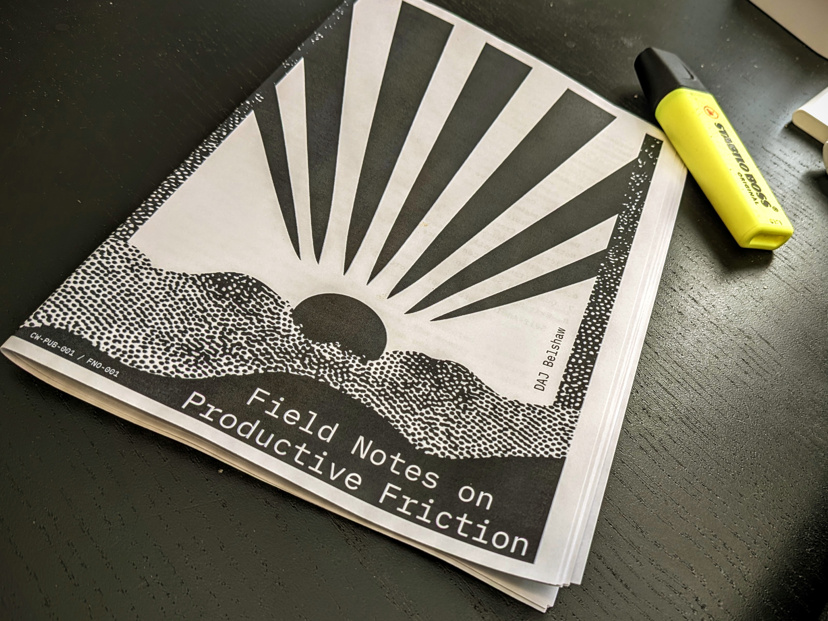 Photo of test print for 'Field Notes on Productive Friction' with the result sitting on a desk next to a highlighter pen